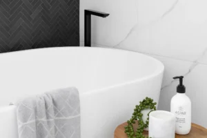 Luxury soaking tub with black matte faucet, marble tile walls, and spa-style accessories perfect for modern bathroom upgrades