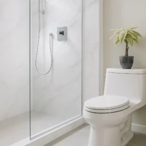 Modern bathroom with glass walk-in shower, large white tiles, and sleek toilet featuring minimalist fixtures and a decorative plant for a clean renovation look